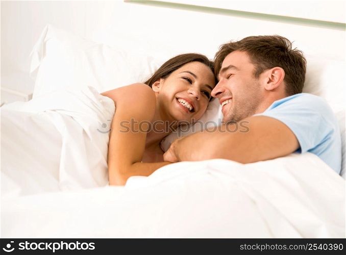 Young couple on bed and having a good time