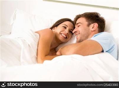 Young couple on bed and having a good time