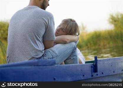 Young couple on blue painted boat Russia