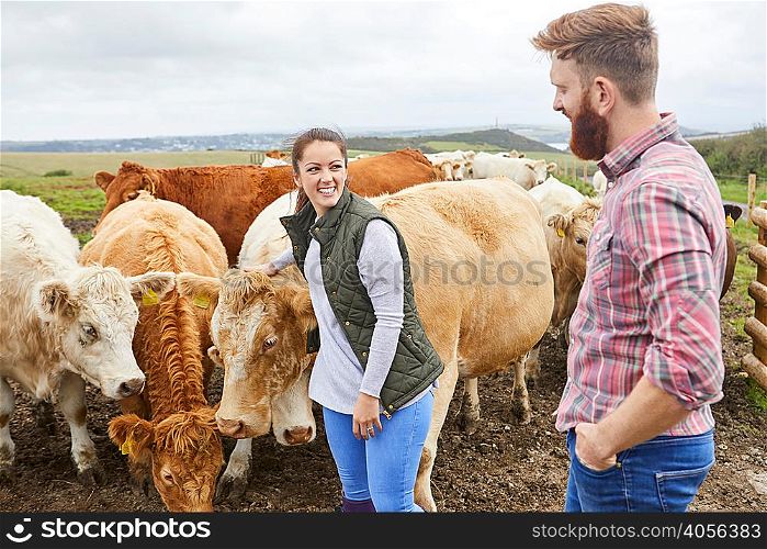 Young couple on cow farm