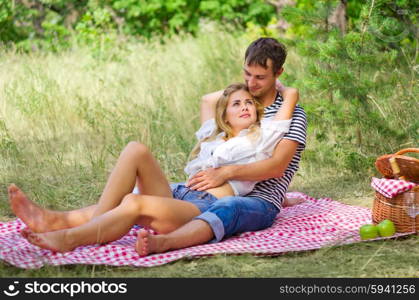 Young couple on picnic at forest