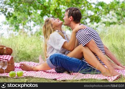 Young couple on picnic at forest