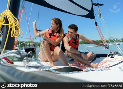 young couple on sailing vessel