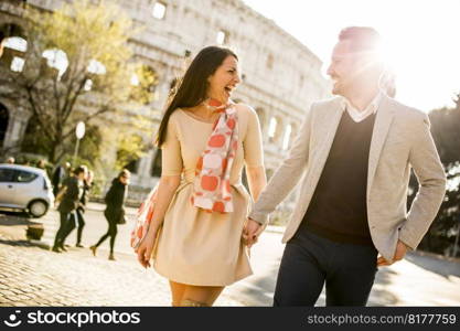 Young couple on the background of the Colosseum, Rome, Italy