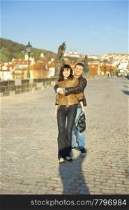 young couple on the Charles Bridge on the skyline