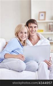 Young couple on the couch with a laptop
