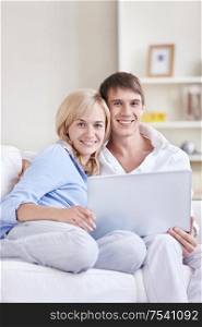 Young couple on the couch with a laptop