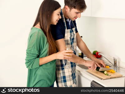 Young couple on the kitchen cooking