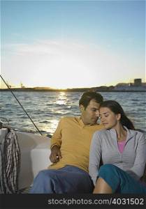 Young couple on yacht sitting portrait