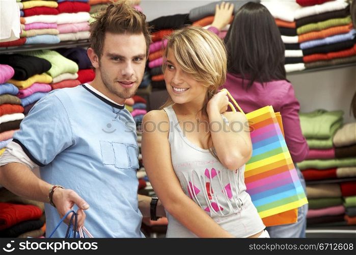 young couple out shopping in a clothes store