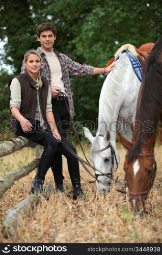 Young couple out with horses