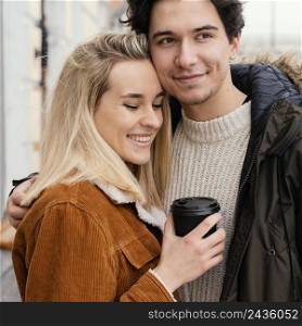 young couple outdoor enjoying cup coffee