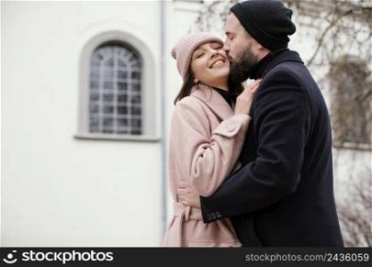 young couple outdoor kissing
