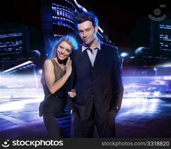 Young couple over the night city background