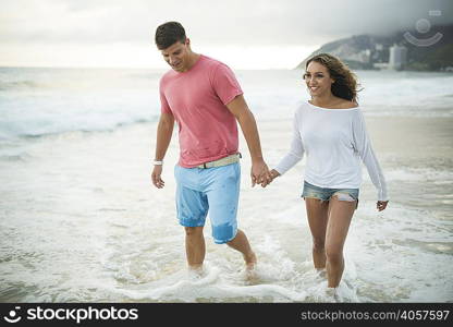 Young couple paddling in ocean, Ipanema Beach, Rio de Janeiro, Brazil