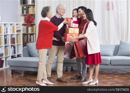 Young couple paying New Year's greetings to their parents