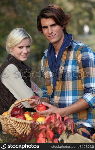 Young couple picking apples