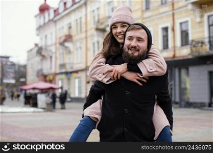 young couple piggy back ride