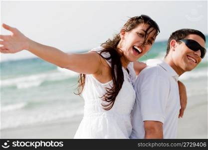 Young Couple Piggybacking Outdoors, Hands Outstretched