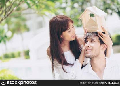 Young couple planning to buy a house and have happy living.. Young couple planning to buy a house concept.