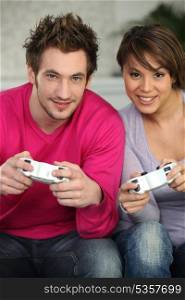 Young couple playing a games console