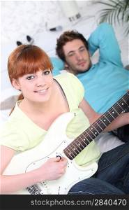 Young couple playing a guitar