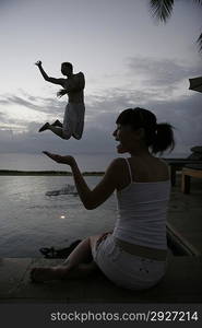 Young couple playing by water