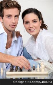 young couple playing chess