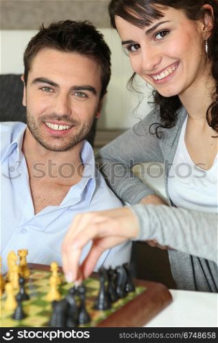 Young couple playing chess
