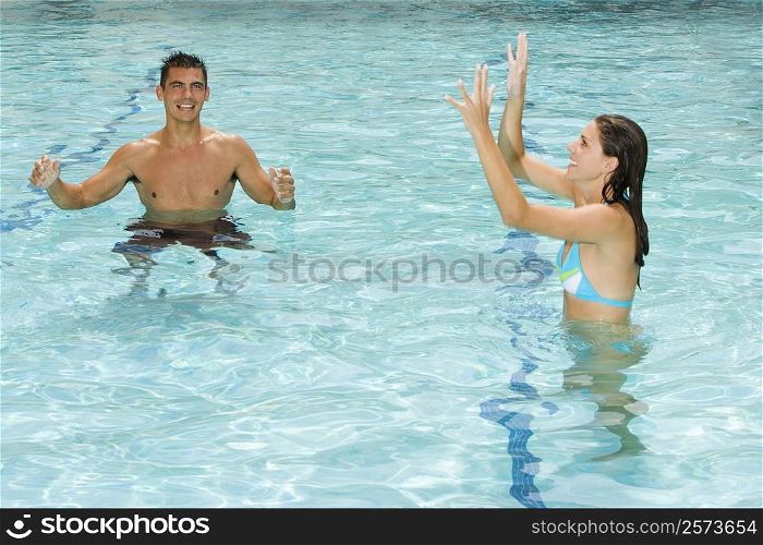 Young couple playing in a swimming pool