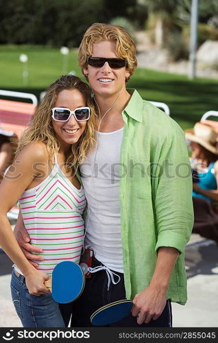 Young couple playing table tennis portrait