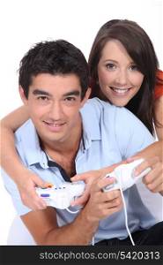 Young couple playing video games together
