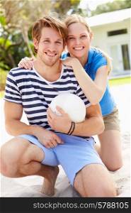 Young Couple Playing Volleyball Match