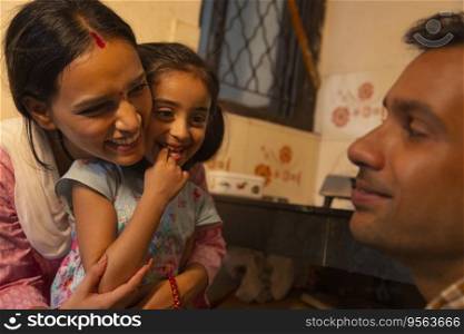Young couple playing with their little daughter in the kitchen