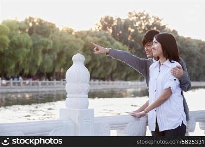Young Couple Pointing by a Lake