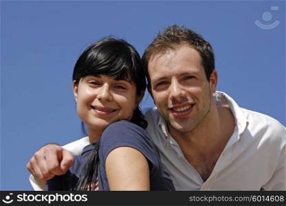 young couple portrait with the sky as background