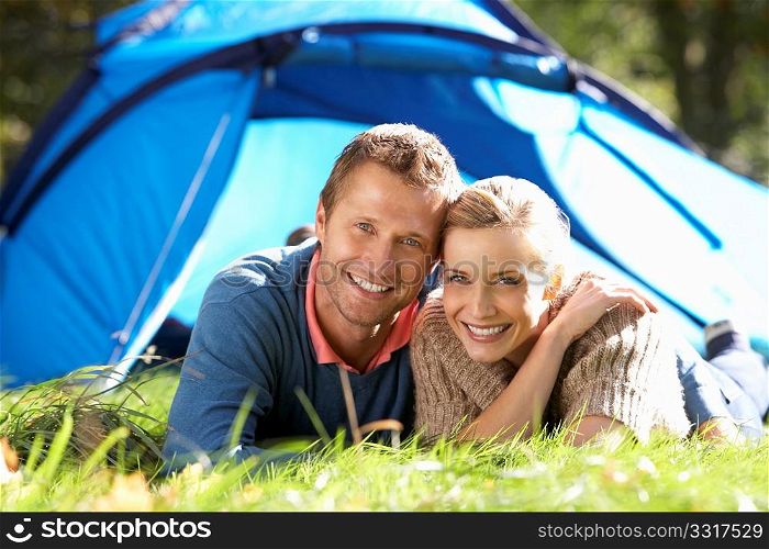 Young couple pose outside of tent
