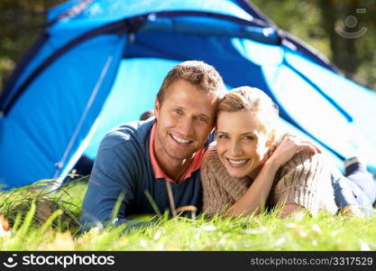 Young couple pose outside of tent