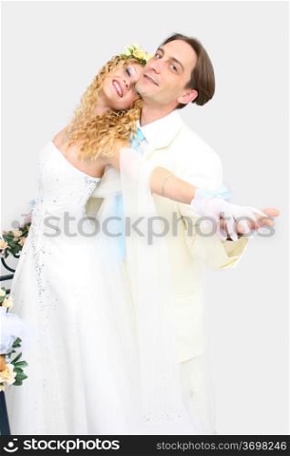Young couple posing in a studio on the wedding day
