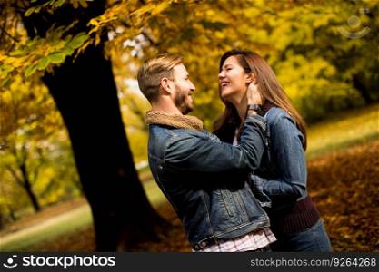 Young couple posing in the autumn park