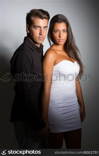 Young couple posing isolated in studio