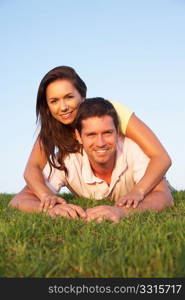 Young couple posing on a field