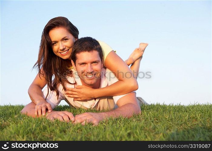 Young couple posing on a field