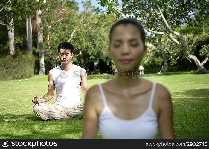 Young couple practising youga