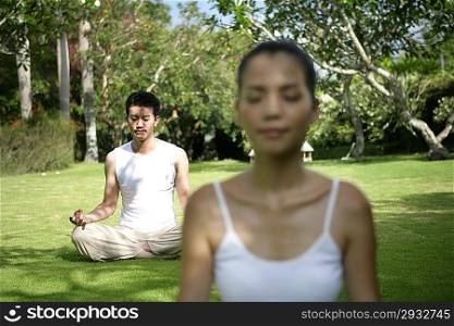 Young couple practising youga