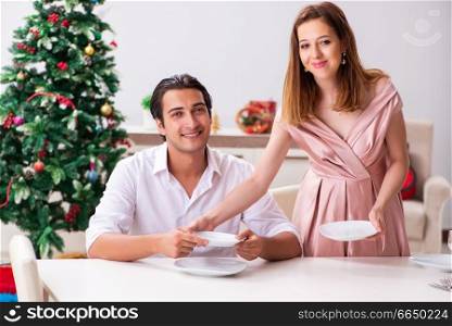 Young couple preparing for christmas meal