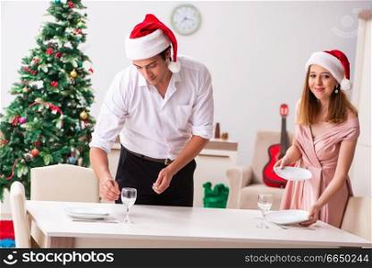 Young couple preparing for christmas meal