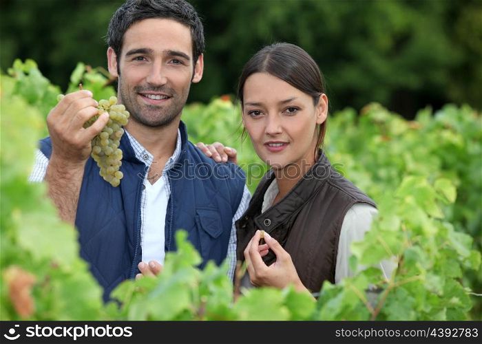 young couple proud of their vineyard