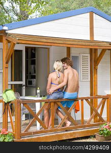 Young couple relax on beach cabin terrace