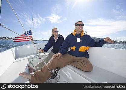 Young couple relax on deck of sailing boat